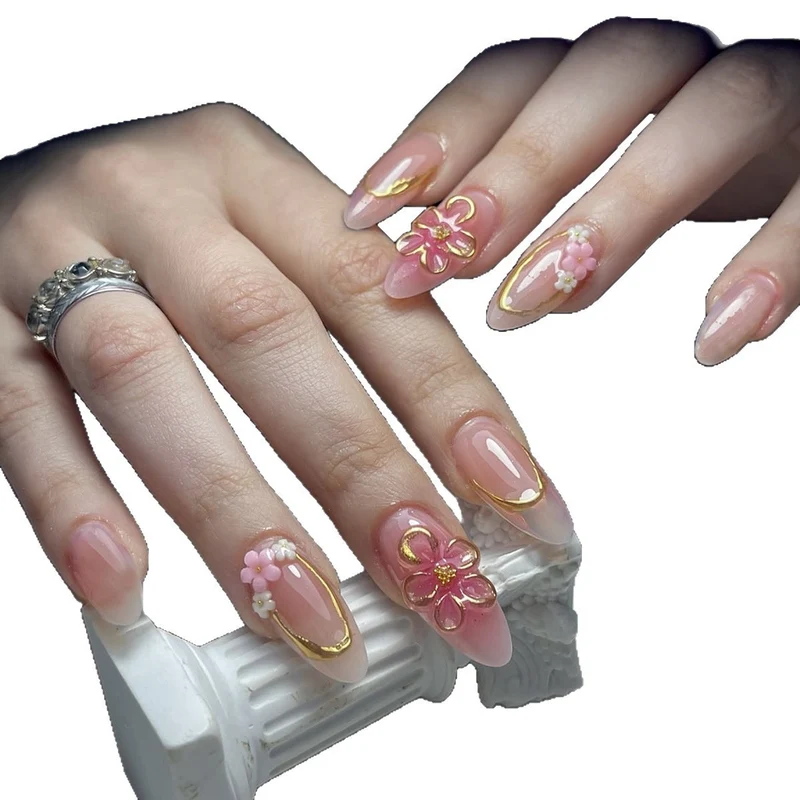 Kunstnagelset mit eleganten Blüten- und Goldverzierungen Karnz