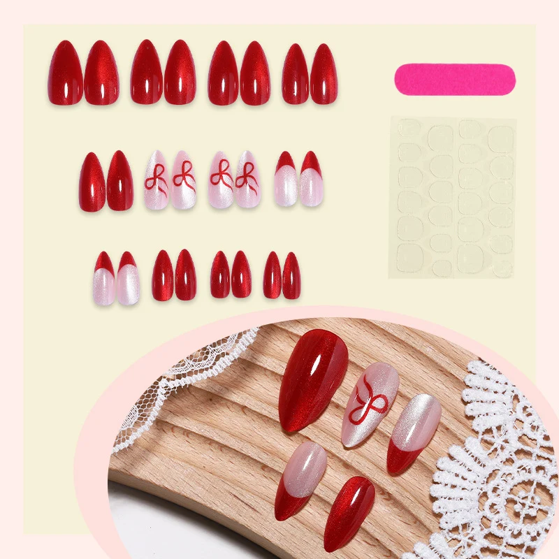 Kunstnagelset mit elegantem Rot und zarten Schleifenakzenten Karnz