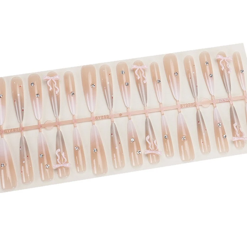 Elegante Stiletto Press-On Nägel mit dekorativem Bogen und Strassakzenten Karnz