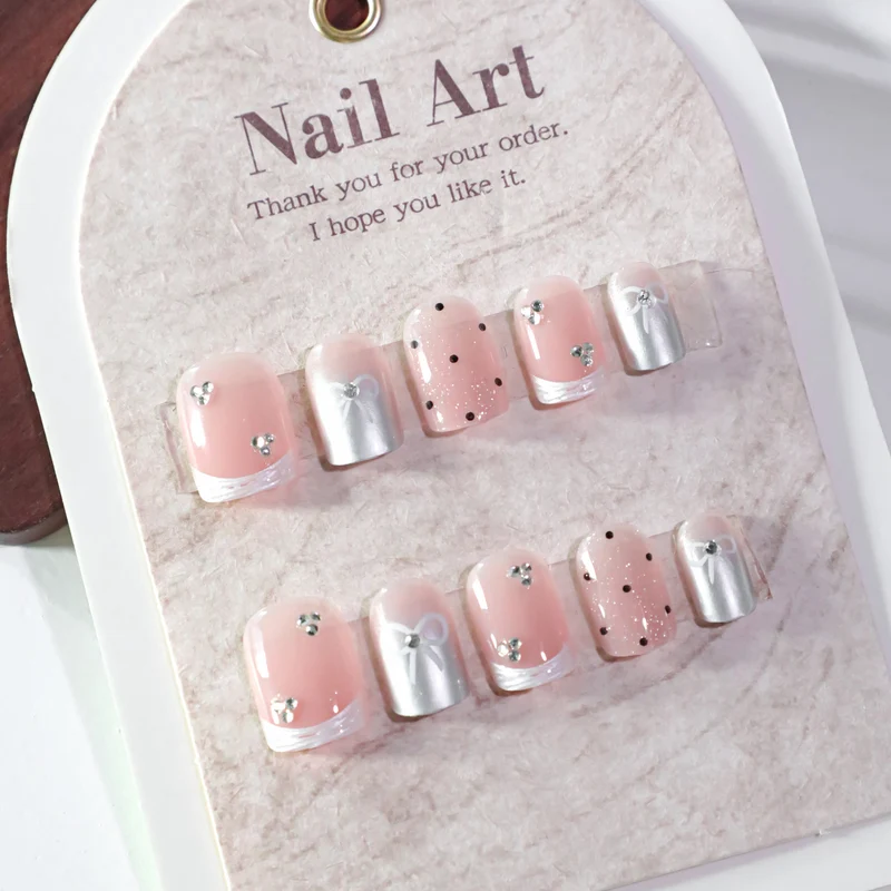 Kunstvolle Nagelkunst mit Schleifen- und Glitzerakzenten Karnz