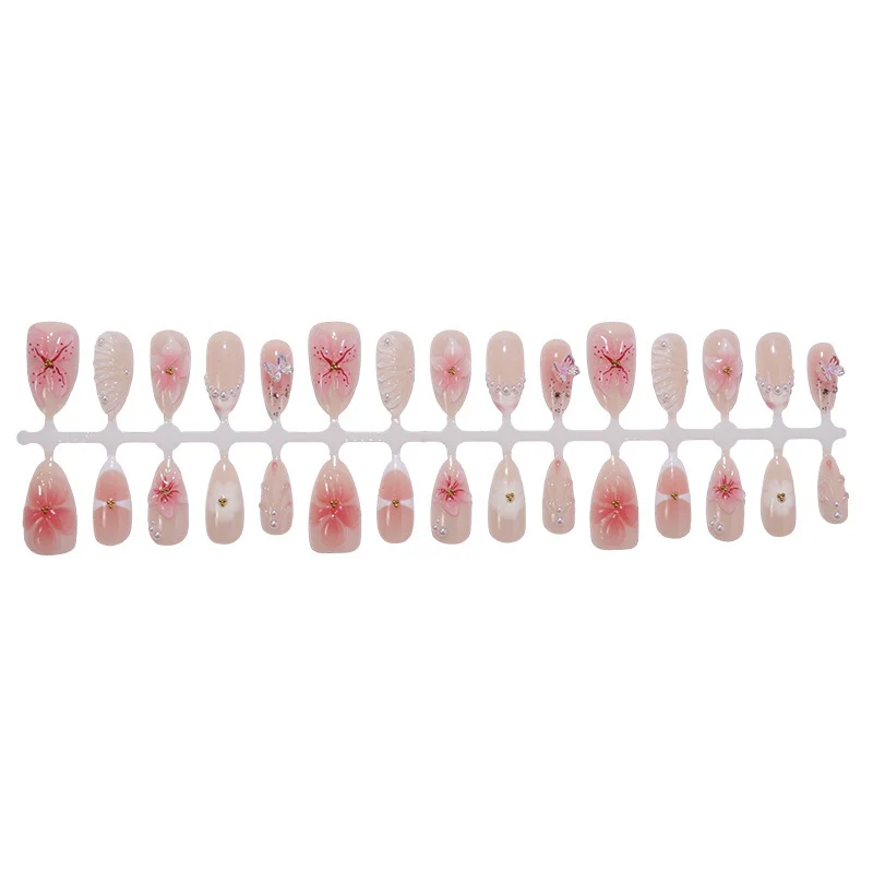Kreatives Kunstnagelset mit filigranen Blüten- und Glitzerverzierungen Karnz