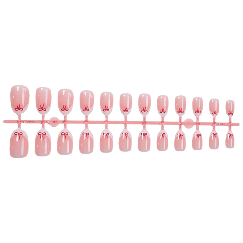 Kunstnagelset mit zarten Schleifenmotiven Karnz