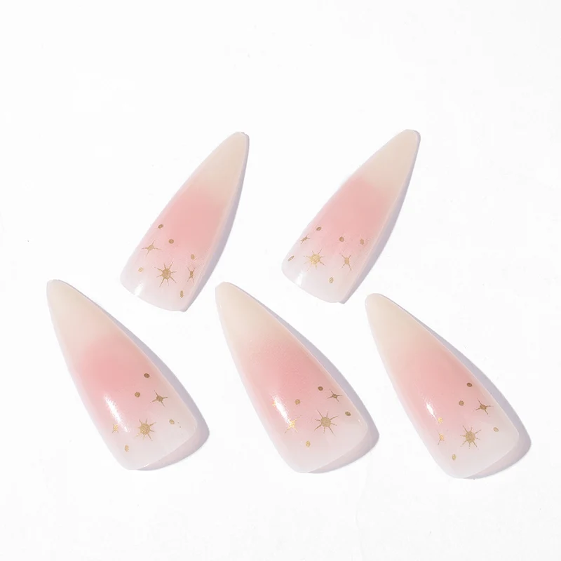 Kunstnagelset mit zartem Ombre-Design und glamourösen Sternakzenten Karnz