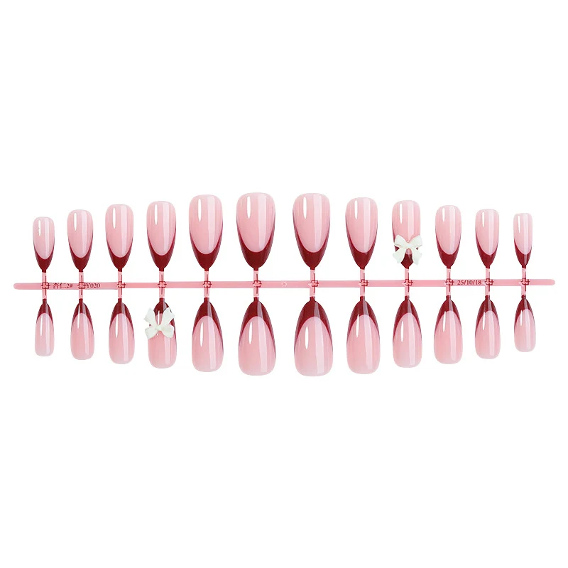 Kunstnagelset mit kreativem French-Tip Design und niedlichen Schleifen Karnz