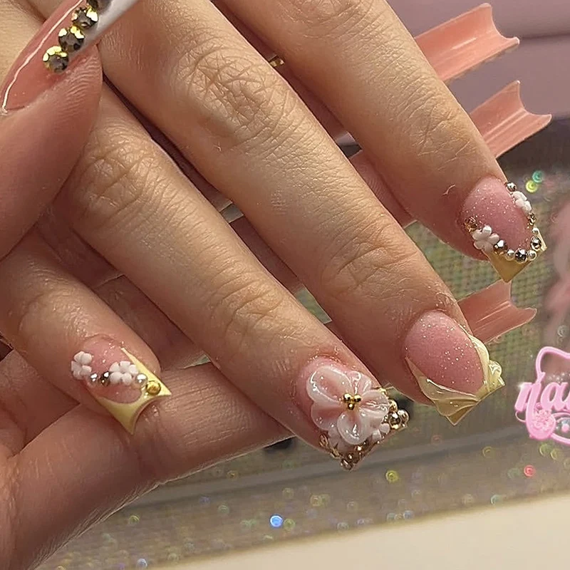 Kunstnagelset mit glamourösen Glitzer- und Blumenakzenten Karnz