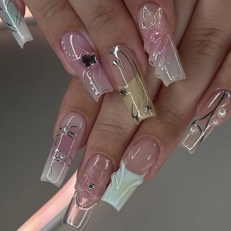 Kunstnagelset mit eleganten Ombre-Designs und Glitzerakzenten Karnz